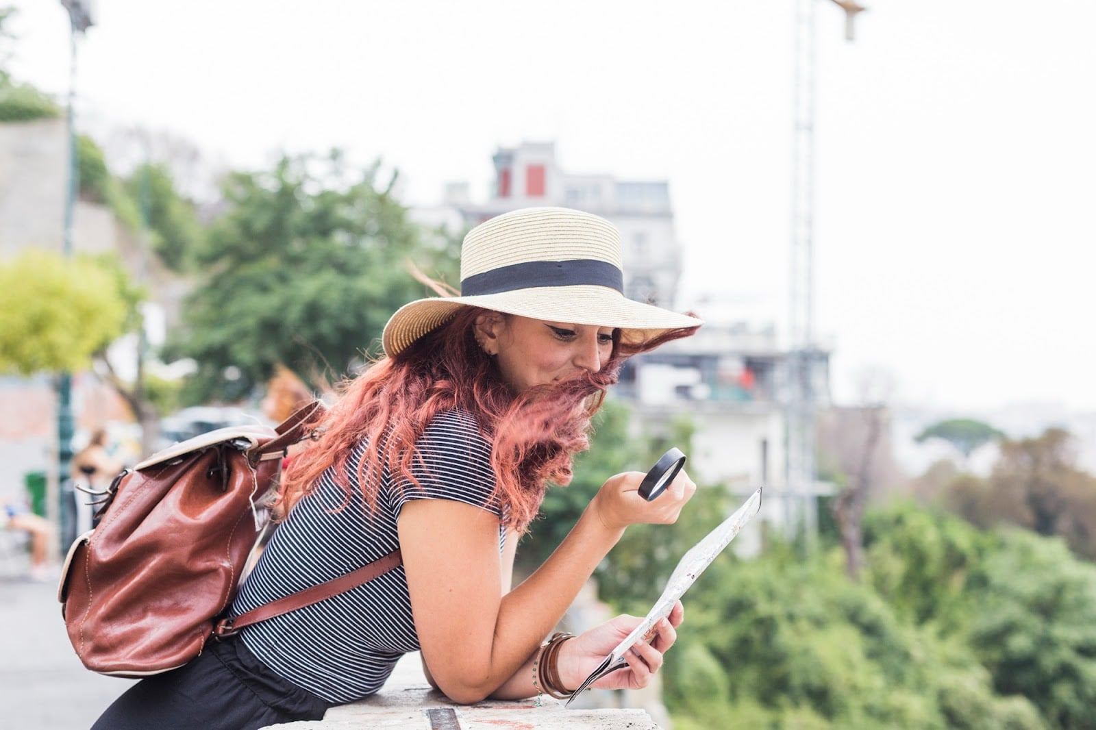 a woman using a magnifying lens to look at a map
