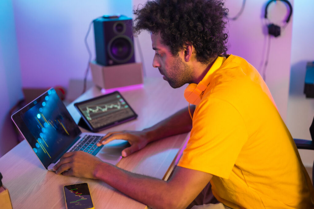 Trader working in a indoor studio using laptop