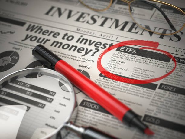 ETF is the best option to invest. Where to Invest concept, Investments newspaper with ñoupe and marker.