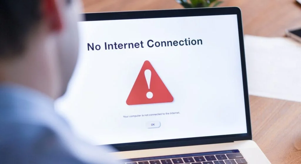 An image of a man staring at a laptop screen which has the inscription “No Internet Connection”