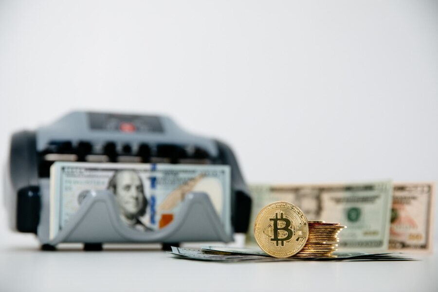 Close-up picture of Bitcoin and dollars