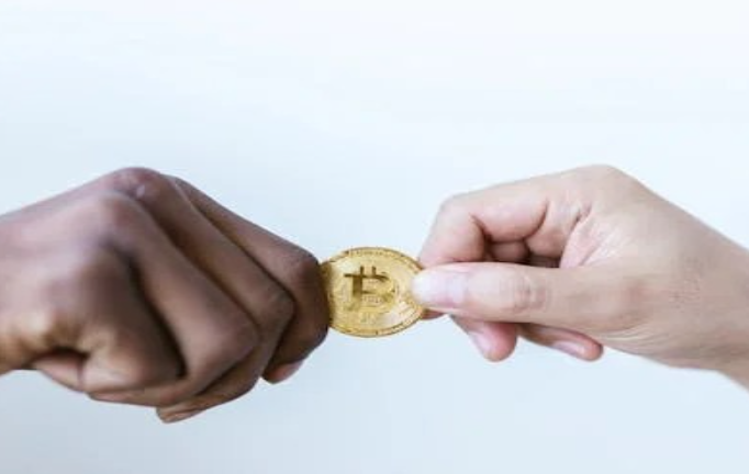 Close-Up Shot of Two People Holding a Gold Coin