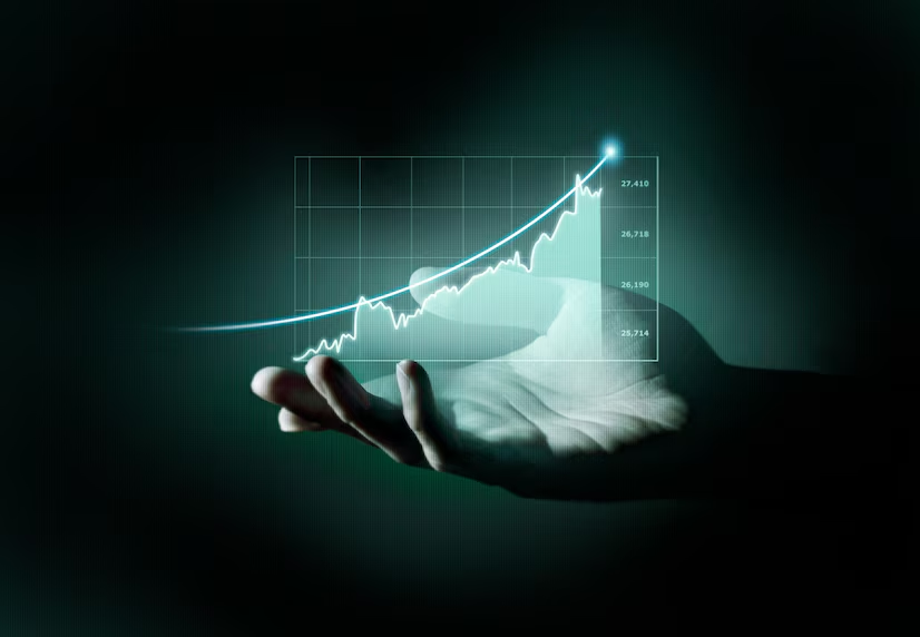 A hand holding a graph showing upward growth