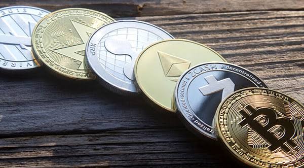Bitcoin and other crypto spread out on a table