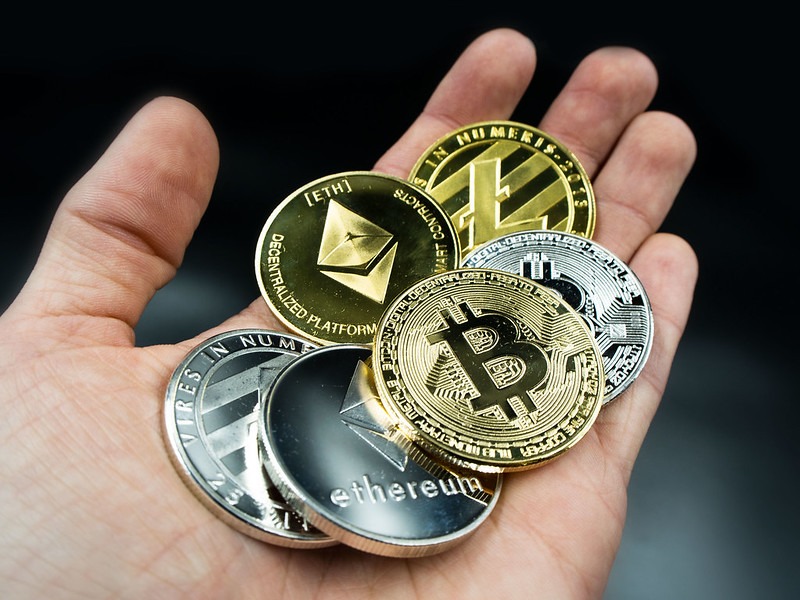 A hand with crypto coins in them