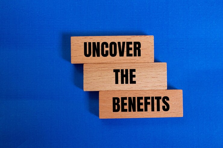 "Uncover the benefits" written on wooden blocks against a blue background.