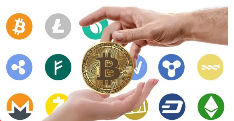 Various cryptocurrency logos surrounding a Bitcoin coin held between hands