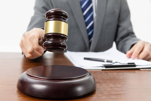 Person with gravel and papers on the table