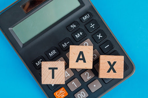 Block letters of TAX on a calculator