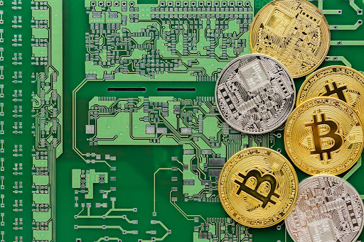 Crypto coins placed on a green circuit board