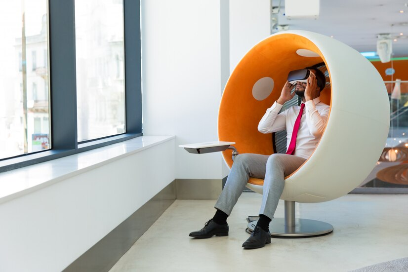Businessman using VR headset in pod chair