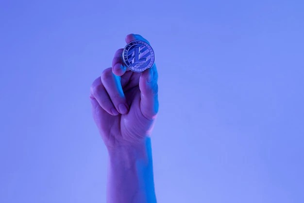 Selective Male Hand with Golden Litecoin Coin