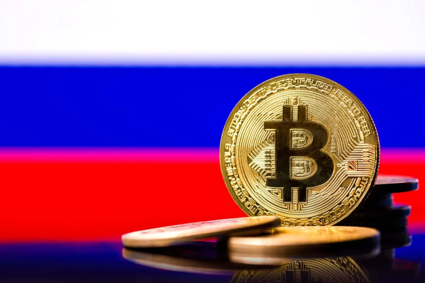 Bitcoin coin displayed against the Russian flag, representing cryptocurrency activity and regulation in Russia.